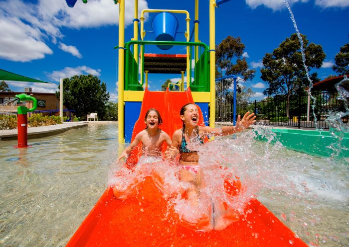Kids sliding on a waterslide at Discovery Parks, Dubbo