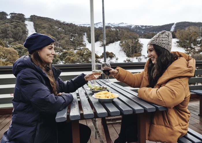 Women enjoying food and drink at The Local Pub in Thredbo Village, Snowy Mountains.