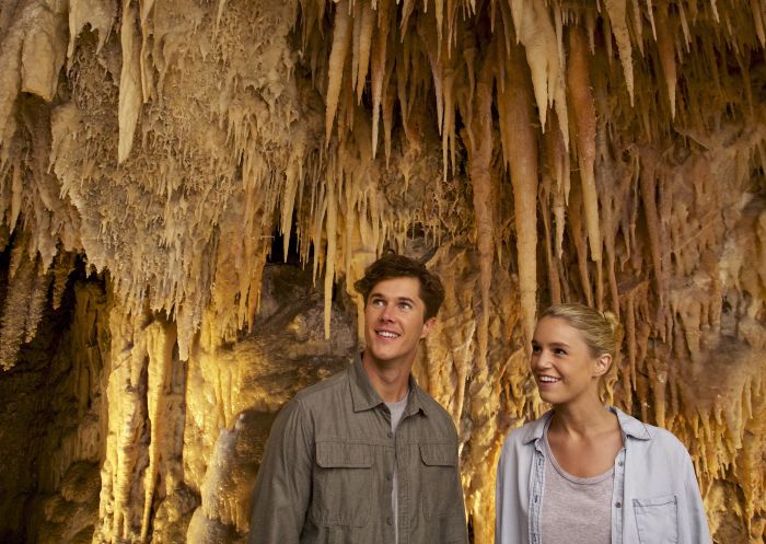 Couple enjoying a day exploring the Jillabenan Cave (part of the Yarrangobilly Caves limestone karst system) in Kosciuszko National Park