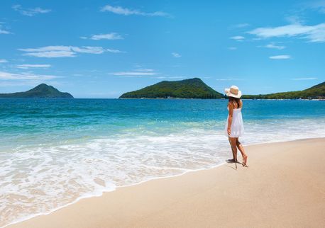 Woman enjoying views of Mount Tomaree from Shoal Bay in Port Stephens