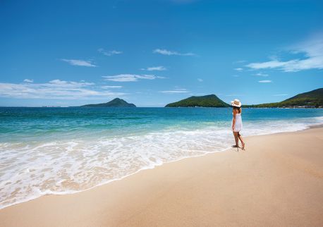 Woman enjoying views of Mount Tomaree from Shoal Bay in Port Stephens