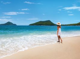 Woman enjoying views of Mount Tomaree from Shoal Bay in Port Stephens