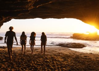 Watch the sunrise from a beach cave