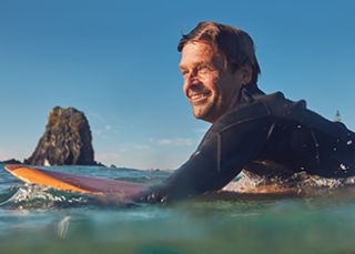 Man surfing at Glasshouse Rocks, Eurobodalla NSW