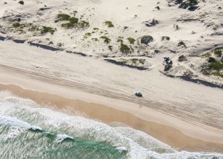 4WD driving along the beach on Worimi Conservation Lands, Port Stephens