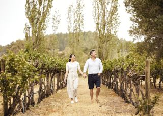 Couple enjoying a walk through the Helm Wines vineyard in Murrumbateman, Yass Area