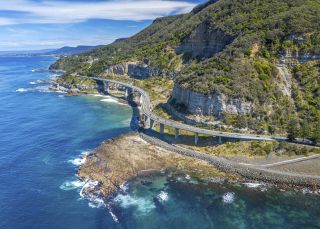 Aerial view of road across ocean, Grand Pacific Drive, Stanwell Tops