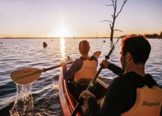 Couple enjoying an afternoon of kayaking along Lake Mulwala in Mulwala, The Murray
