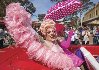 Glamourous hosts Philmah Bocks and Art Simone roll through Main Street, Broken Hill during the Broken Heel Street Parade