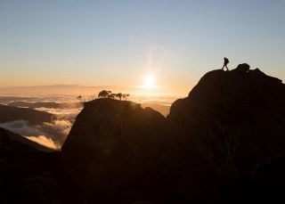 Hiker enjoying a scenic sun set at Kosciuszko National Park, Kosciuszko