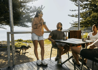 Group of friends relaxing on porch, NRMA Murramarang Beachfront Holiday Resort, South Durras