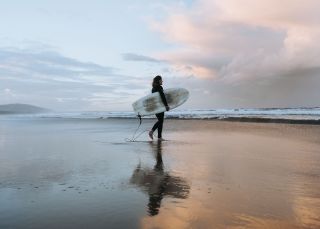 Surfer heading into the surf , Seven Mile Beach, Gerroa