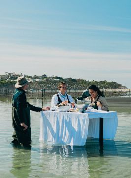 Couple on an oyster tasting experience on the waters of Merimbula Lake, Merimbula Oyster Tours, Merimbula