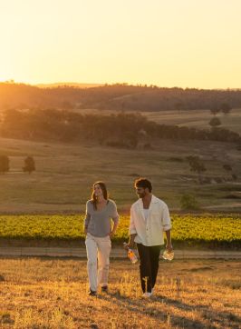 Couple enjoying a walk through the vineyard at De Beaurepaire Wines, Rylstone