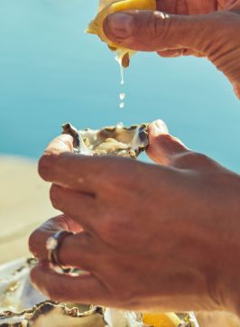 Couple enjoying fresh oysters and wine at Tuross Boatshed & Cafe, Tuross Head