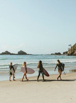 Surfers walking on beach, Broken Heach Beach, Byron Bay