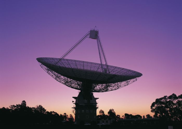 The CSIRO Radio Telescope at twilight with pink-purple sky, with new antenna in Parkes