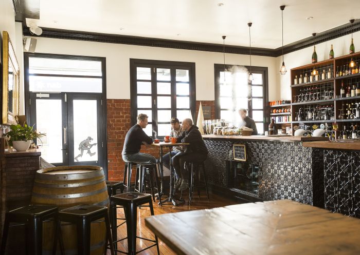 Men enjoying hot beverages at the Commercial Boutique Hotel in Tenterfield.