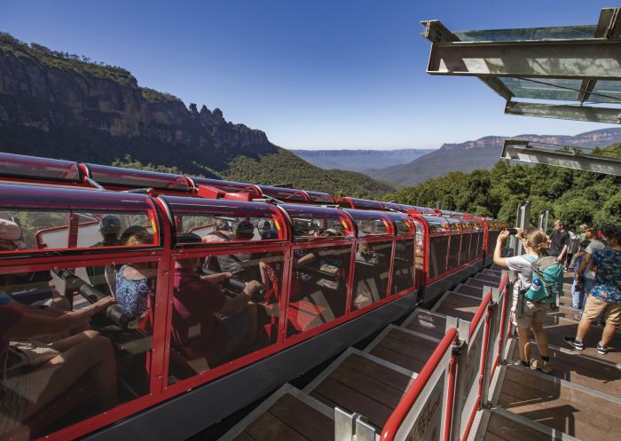 Tourists watching the Scenic Railway train descending the Jamison Valley at Scenic World, Katoomba in the Blue Mountains
