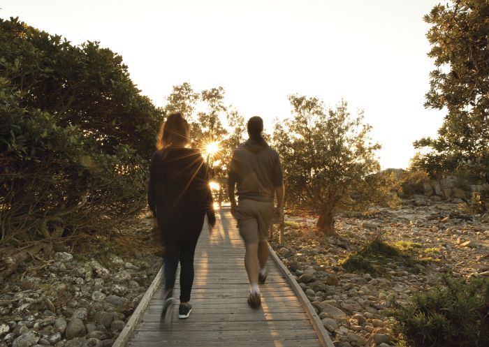 Couple enjoying a morning walk along the Aragunnu Walking Track in Mimosa Rocks National Park