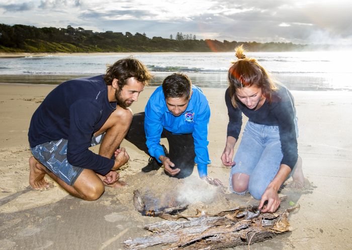 Tourists learning the local knowledge of the Gumbaynggirr people on an Unkya Cultural Eco Tour at Gaagal Wanggaan (South Beach) National Park, Scotts Head