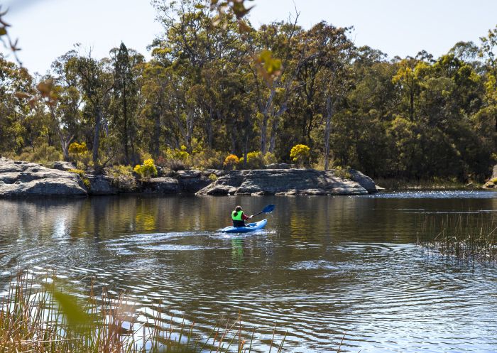 Woman enjoying an afternoon kayak through Dunns Swamp in Wollemi National Park