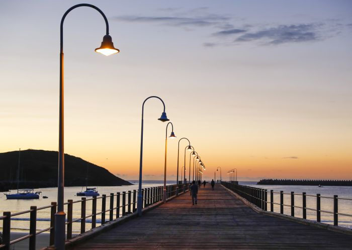 The sun rises over the pier at Jetty Beach in Coffs Harbour, North Coast