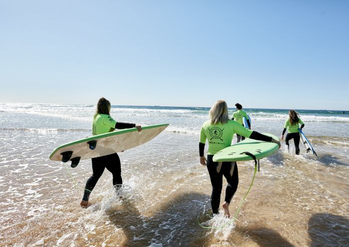Women learning how to surf with Illawarra Surf Academy on Corrimal Beach near Wollongong, South Coast