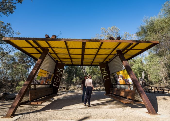 Visitors reading the information signs on a visit to the Peak Hill Open Cut Gold Mine in Parkes Shire