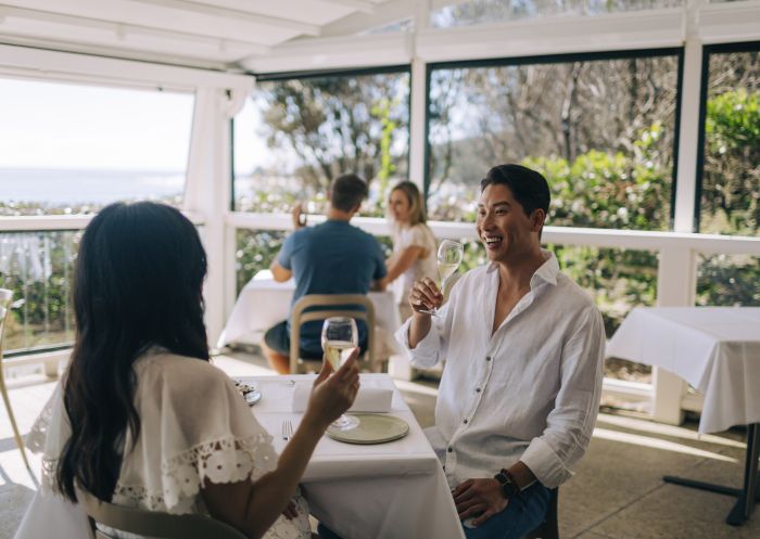 Couple enjoying food and drink at Beach Byron Bay, Byron Bay