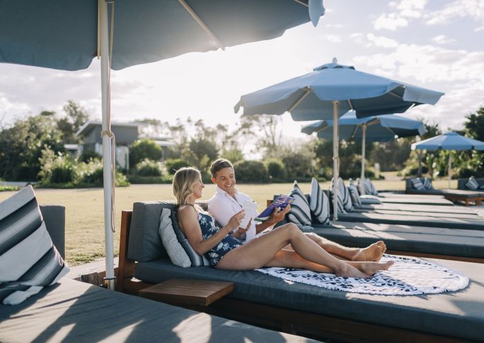 Couple relaxing at the Botanica Beach Club, exclusive to guests staying at Elements of Byron Resort, Byron Bay