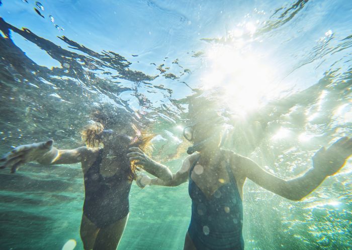 Mother and daughter enjoying a morning swim at Guerilla Bay in the Eurobodalla, South Coast