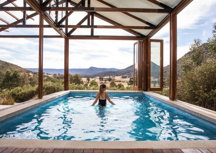 Woman relaxing in a seven metre-long private pool at Emirates One&Only Wolgan Valley, Blue Mountains