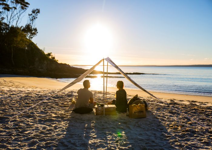 Couple enjoying a picnic packed by Hyams Beach Hampers at Blenheim Beach in Jervis Bay, South Coast