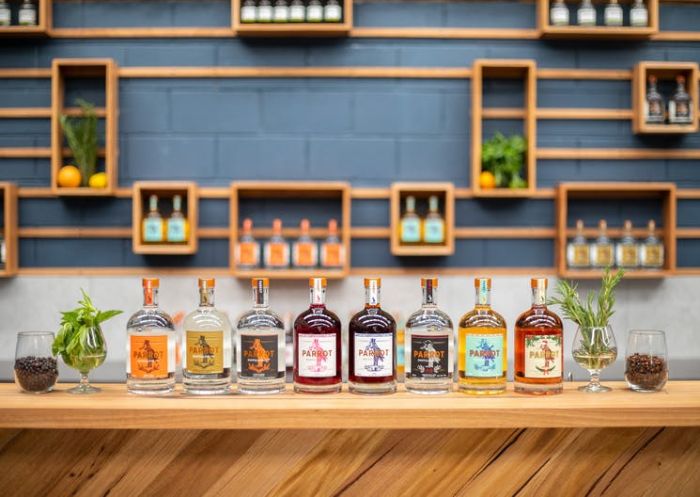 A selection of gin bottles on a wooden bar top at Parrot Distilling Co, Orange - Credit: Parrot Distilling Co