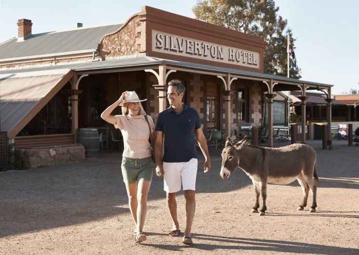 Ein Paar mit einem einheimischen Esel vor dem Silverton Hotel in Silverton , Broken Hill, im Hinterland