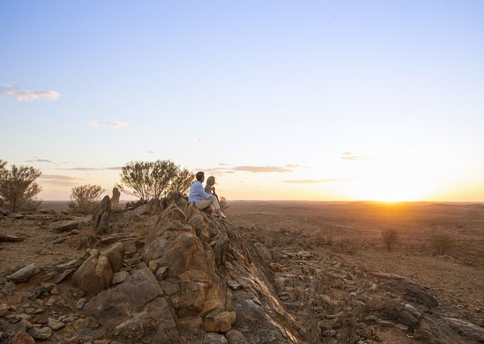 Couple enjoying the sunset from The Living Desert Reserve in Broken Hill, Outback