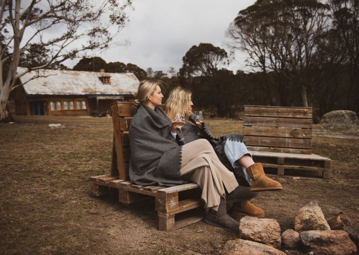Having drinks and relax in the front of bonfire in Cooma, Snowy Mountains