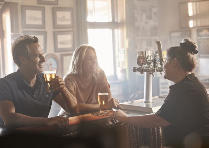 Couple enjoying a beer at Silverton Hotel, Silverton in Broken Hill Area, Outback NSW