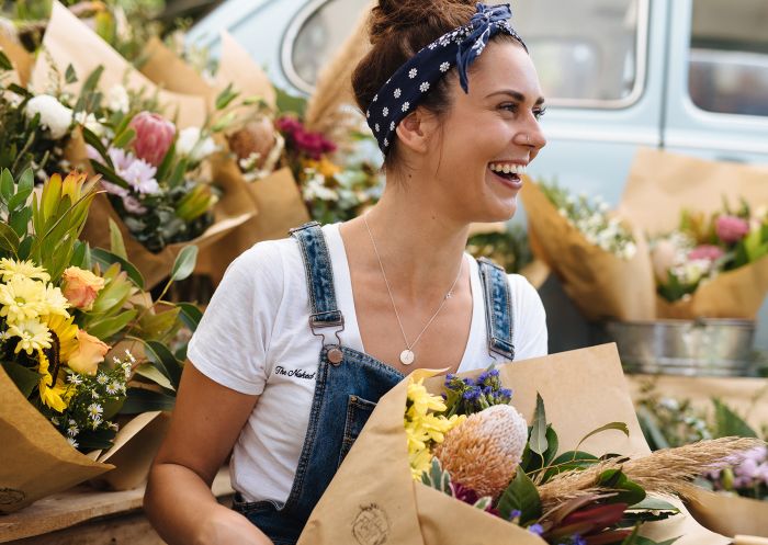 A florist woman selling flowers at Olive Tree market, Newcastle 