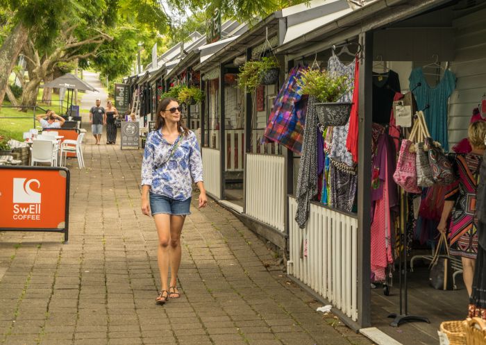  Woman walking past stores on Collins Street in Kiama's town centre