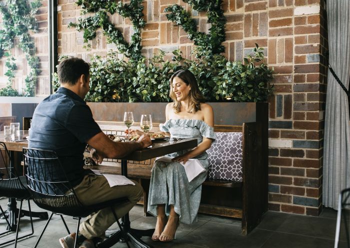 Couple enjoying food and drink at Junction Restaurant, Moama 