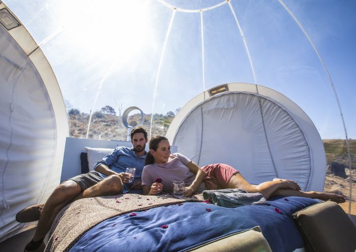 Couple relaxing in their Bubbletent Australia accommodation in the Capertee Valley
