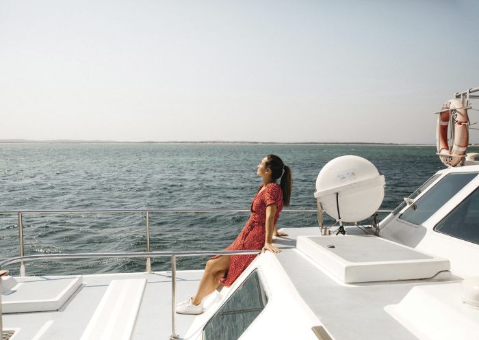 Woman enjoying a dolphin watching cruise with Moonshadow Cruises in Port Stephens