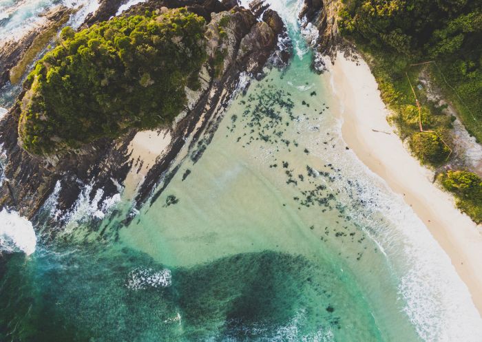 Aerial overlooking the scenic waters off Number One Beach, Seal Rocks