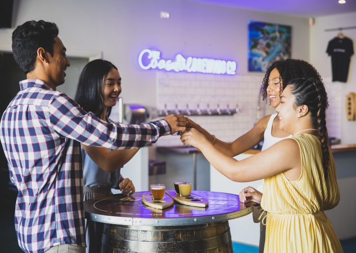 Friends enjoying a flight of beer at The Coastal Brewing Company, Forster
