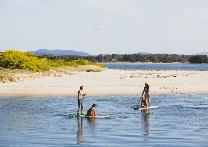Family enjoying a stand up paddleboarding lesson with Jungle Surf on Wallis Lake, Forster-Tuncurry
