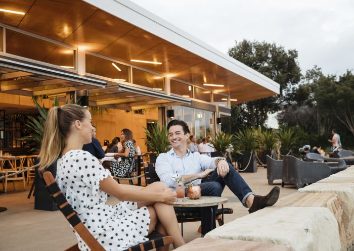 Couple enjoying evening drinks at The BOX on the Water restaurant and bar, Ettalong Beach