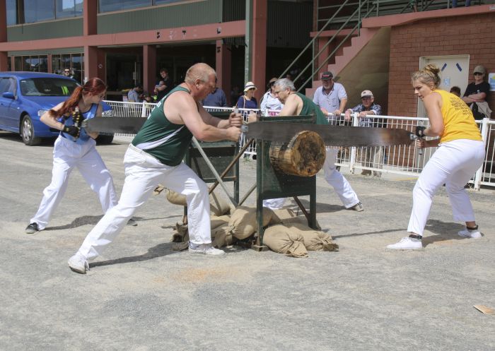 People competing in a woodchopping competition at the Illawarra Festival of Wood, Bulli Showground