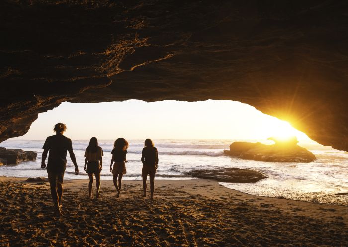 Friends enjoying a warm sunrise from Caves Beach, Lake Macquarie in the North Coast